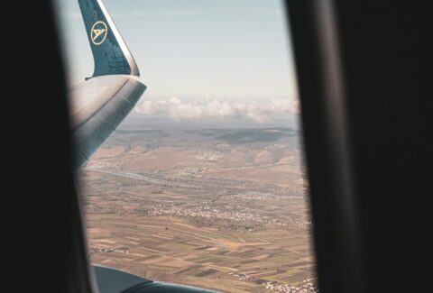 airplane window view of clouds during daytime