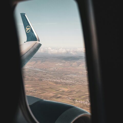 airplane window view of clouds during daytime